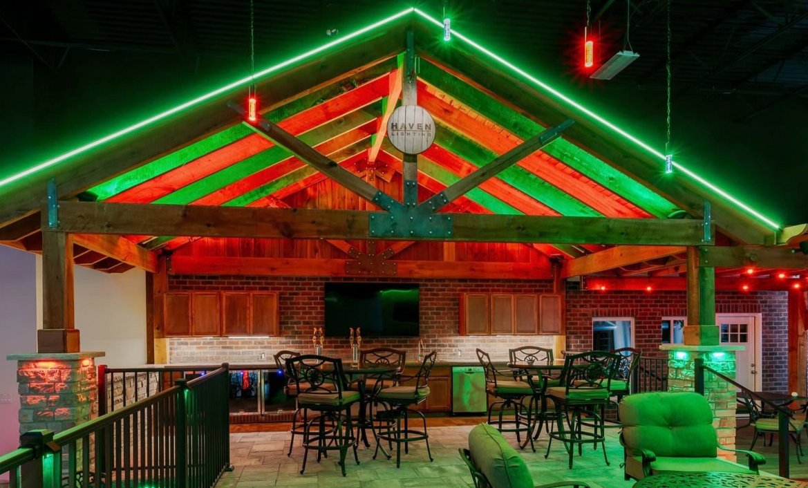 Custom outdoor permanent lighting design illuminating patio and backyard features