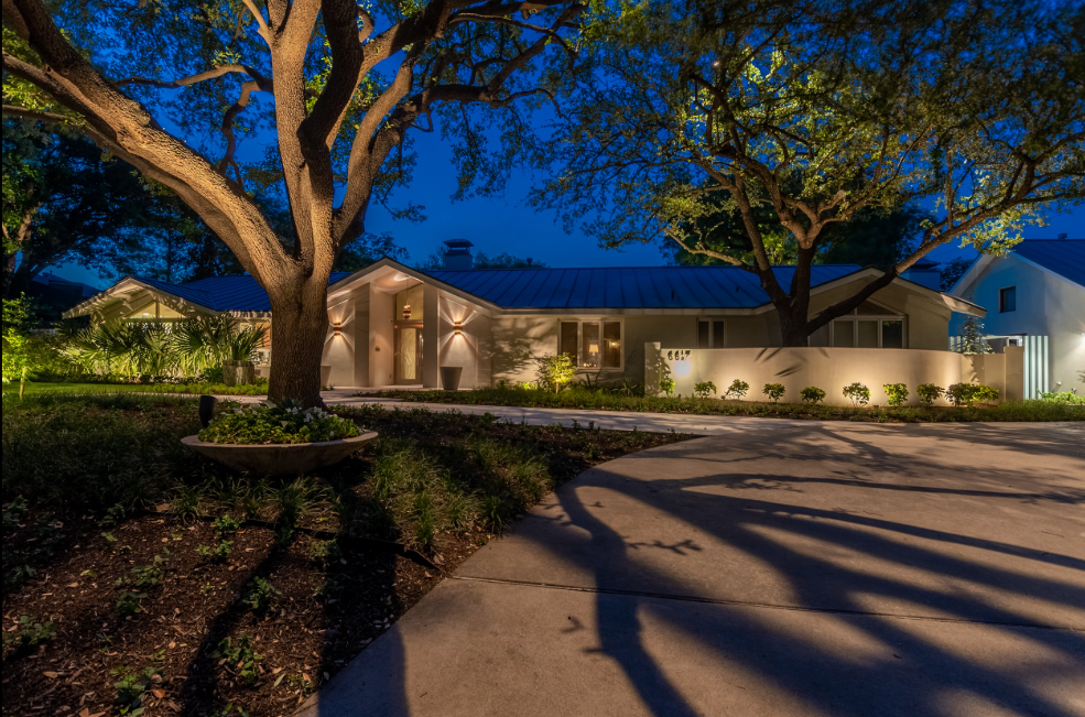 Outdoor landscape lighting illuminating residential home and garden in Lady Lake Florida