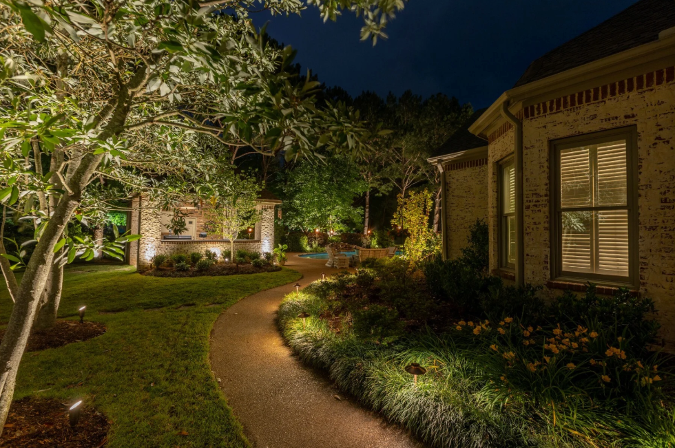 Hardscape and pathway lighting illuminating curved residential walkway in Lady Lake Florida
