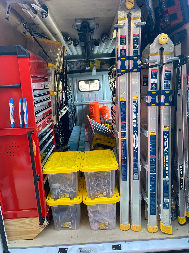 Organized Light Glow work van with ladders, tools, and equipment for professional outdoor lighting installation