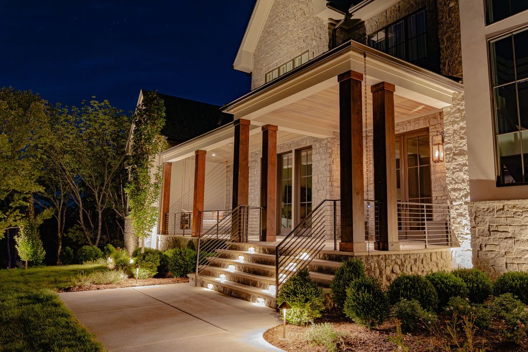 luxury home landscape lighting and pathway lighting illuminating front entry and stairs