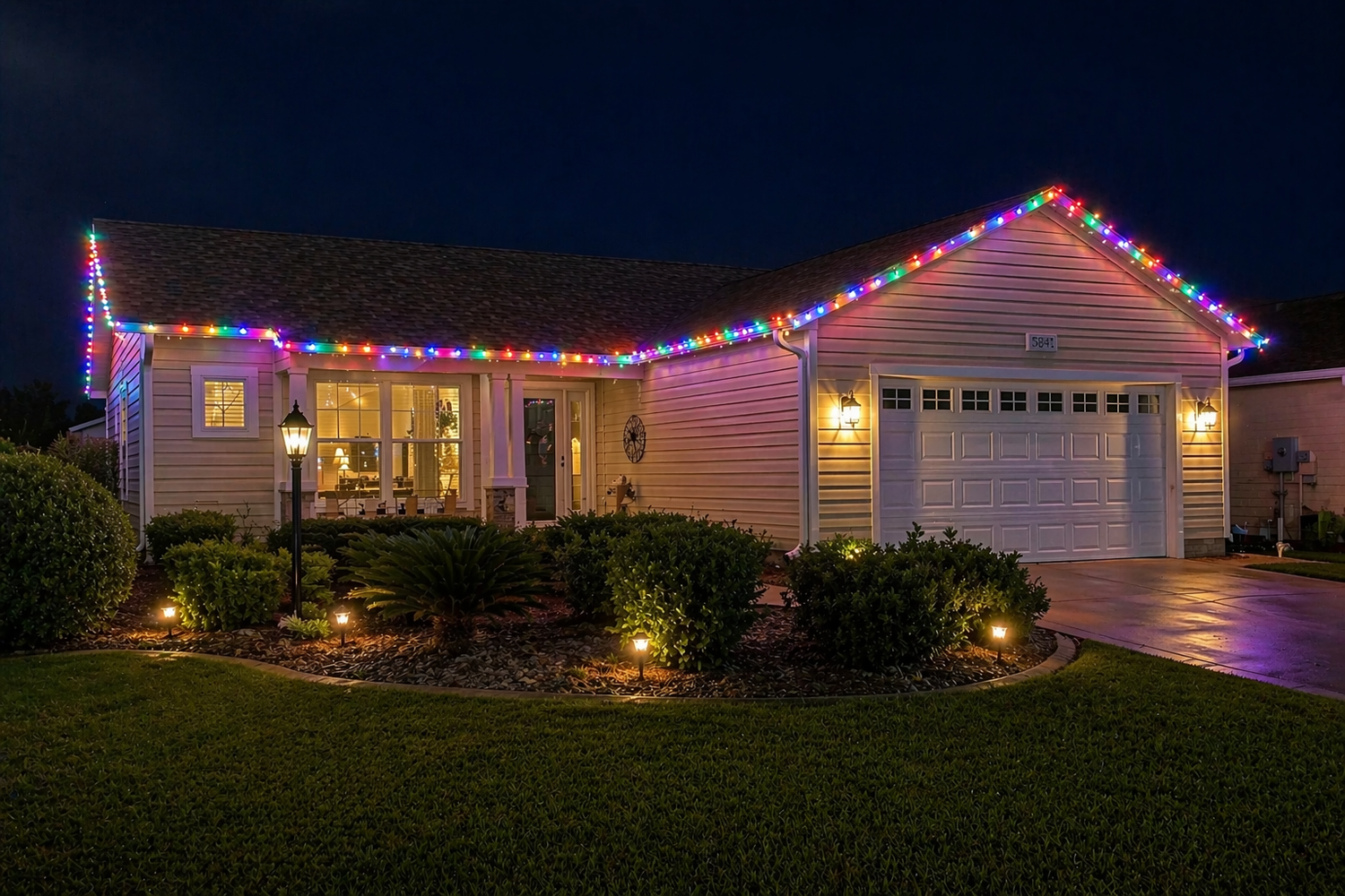 Professional multicolor C9 seasonal roofline lighting installed on a home in The Villages, Florida by Light Glow Outdoor Lighting Solutions.