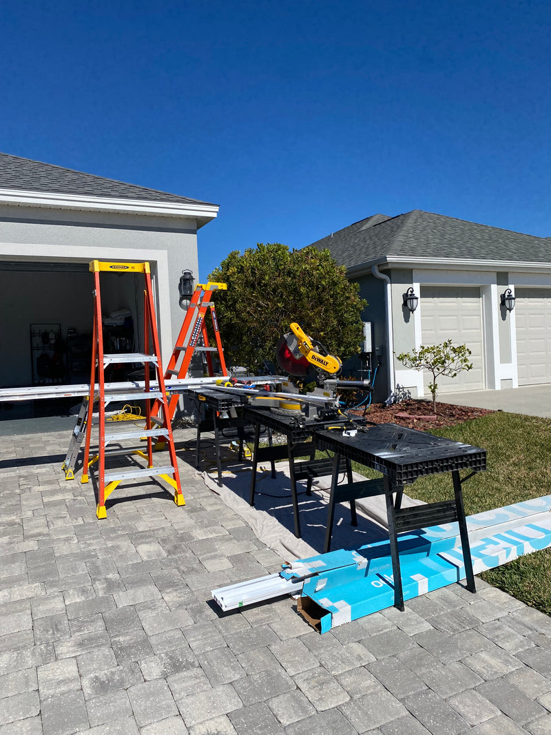 Outdoor lighting installation tools and setup staged in a residential driveway in Florida