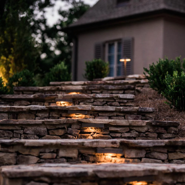 Outdoor step lighting installed in residential hardscape staircase