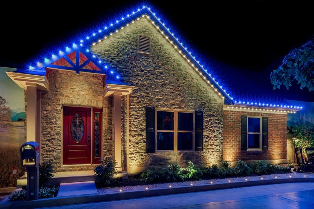 Permanent color-changing LED roofline lighting installation illuminating residential home exterior at night