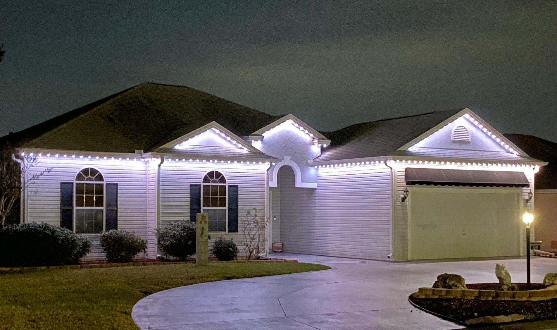 Permanent roofline lighting illuminating residential home exterior in The Villages Florida