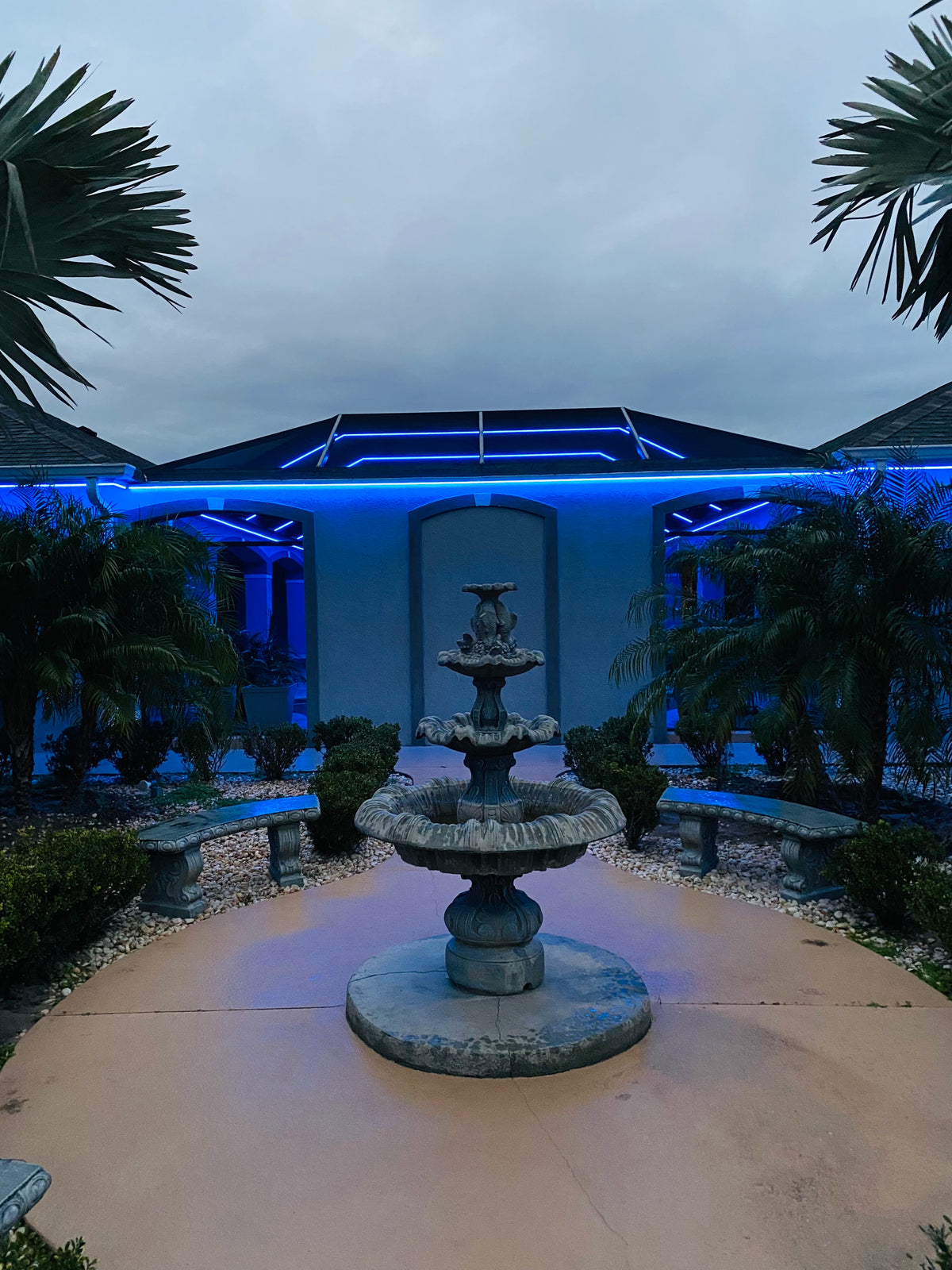 Custom pool cage lighting and roofline lighting with blue LED accents in The Villages Florida outdoor lighting project