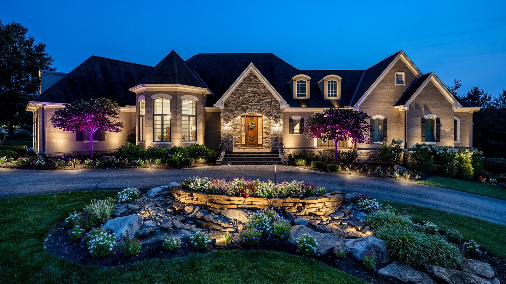 Luxury residential home with professional landscape lighting and exterior architectural lighting design.