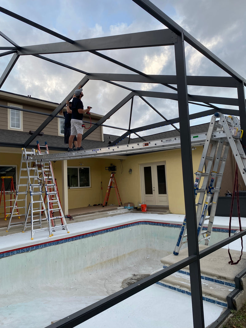 Close-up of permanent lighting installed along a screened pool enclosure roofline in Florida